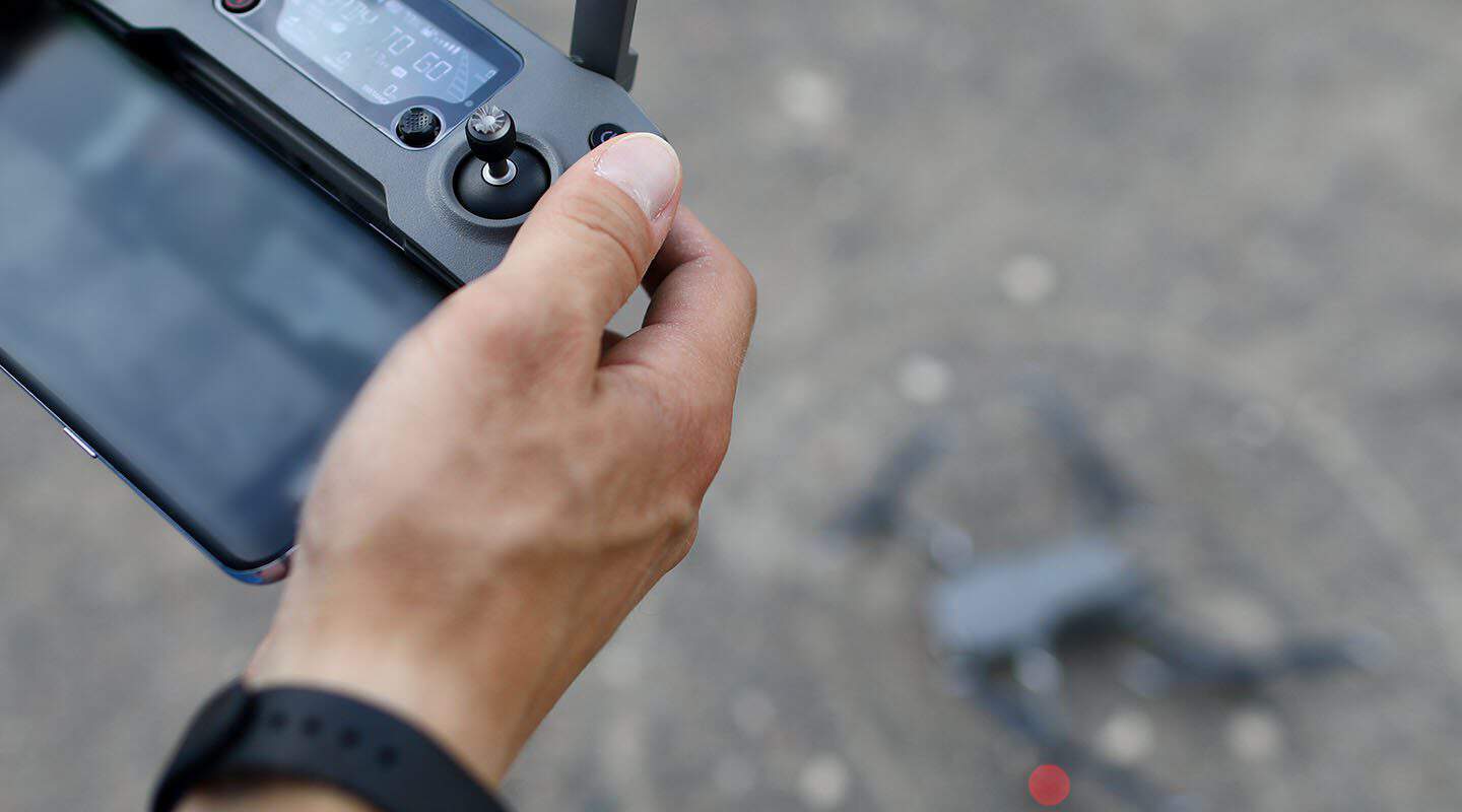 Person holding drone remote